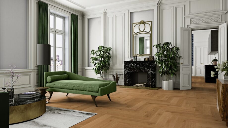 Classical living room with herringbone parquet, marble fireplace, green sofa, round tea table and green courtains.