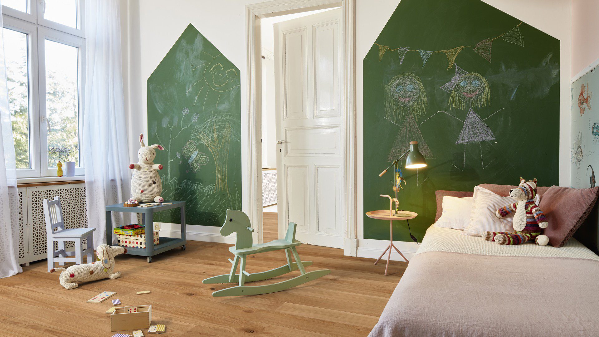 Laudparkett Bauwerk Casapark tamm 46 faasitud, harjatud ja matt lakitud paigaldatud lastetoa põrandale. Lastevoodi mänguasjaga, kiikhobune, laud, pink ja seintel rohelised tahvlid millele kriitidega joonistatud.