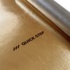 Подложка под ламинат и паркет Quick Step Silent Walk с золотистой пароизоляцией. Рулон наполовину развернут на черновом полу.