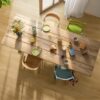 LVT Floors Quick Step Bloom Brushed Oak Honey installed on a dining room floor. Dining table with breakfast and flowers.
